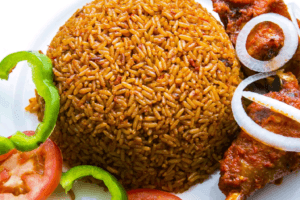 Ghanaian Jollof Rice A plate of rice garnished onions and meat